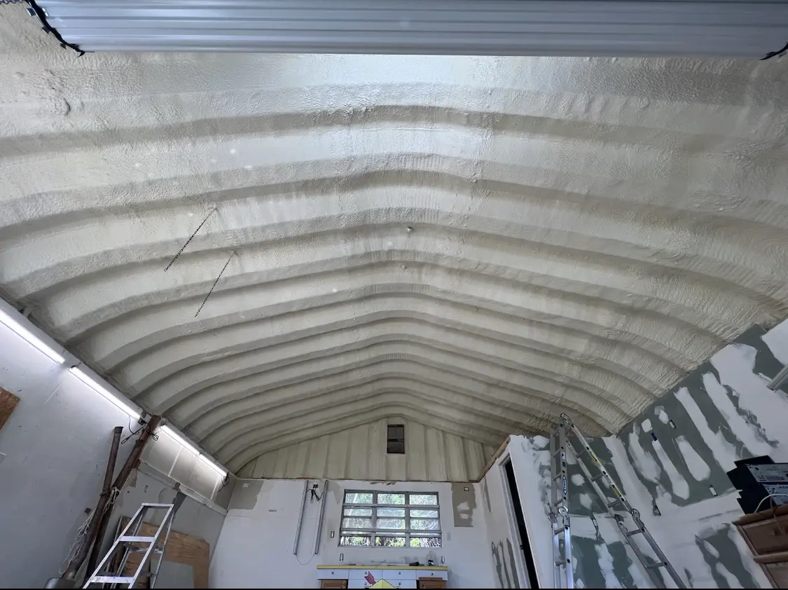 Spray polyurethane foam applied to the underside of a metal roof deck in Corning